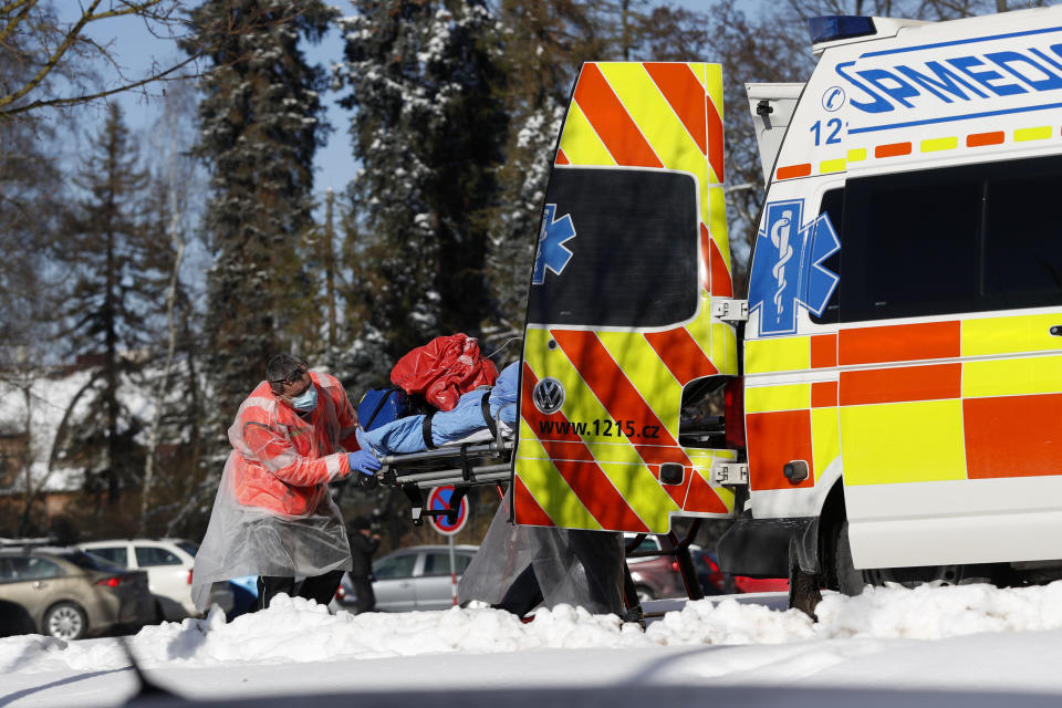 Medical workers move a covid-19 patient at a hospital overrun by the covid pandemic in Cheb, Czech Republic, Friday, Feb. 12, 2021. The Czech government has imposed a complete lockdown of the three hardest-hit counties to help contain the spread of a highly contagious variant of the coronavirus. The meeasures will became effective Friday for the two counties in western Czech Republic on the German border Cheb and Sokolov and another county in the northern part of the country Trutnov located on the border with Poland. (AP Photo/Petr David Josek)