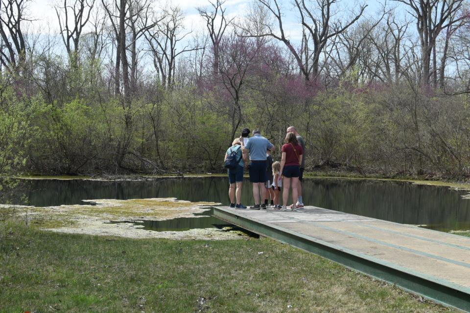 Visitors get a close-up look at a “Blue Hole” fresh water aquifer at the Castalia State Fish Hatchery open house held Saturday.