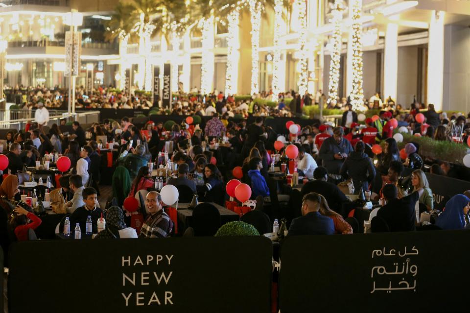 People gathered outside the Burj Khalifa as they waited for the fireworks (REUTERS)