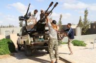 Libyan fighters from the Bonyan Marsous Brigades prepare their weapons before a battle with Islamic State fighters in neighborhood Number Two in Sirte, Libya. REUTERS/Hani Amara