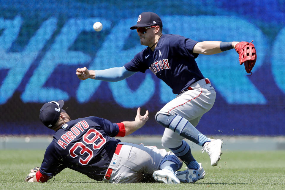 Boston Red Sox second baseman Christian Arroyo (39) and center fielder Kiki Hernandez (5) collide as they go after a hit by Kansas City Royals' Hunter Dozier in the fifth inning of a baseball game at Kauffman Stadium in Kansas City, Mo., Sunday, June 20, 2021. Arroyo was taken out of the game after getting injured on the play. (AP Photo/Colin E. Braley)