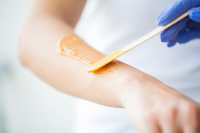 Sugaring removes hair using just sugar, water and lemon. Oh, and wax strips. [Photo: Getty]
