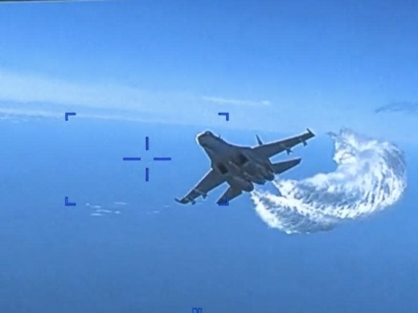 A fighter jet curving upward