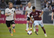 Colorado Rapids midfielder Bryan Acosta, right, clears the ball next to San Jose Earthquakes midfielder Jackson Yueill during the first half of an MLS soccer match Saturday, June 3, 2023, in Commerce City, Colo. (AP Photo/David Zalubowski)