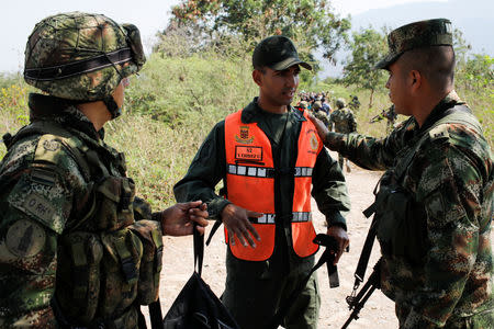 A member of the Venezuelan National Guard who defected to Colombia talks to Colombian soldiers near the Venezuelan-Colombian border in Cucuta, Colombia February 25, 2019. REUTERS/Marco Bello