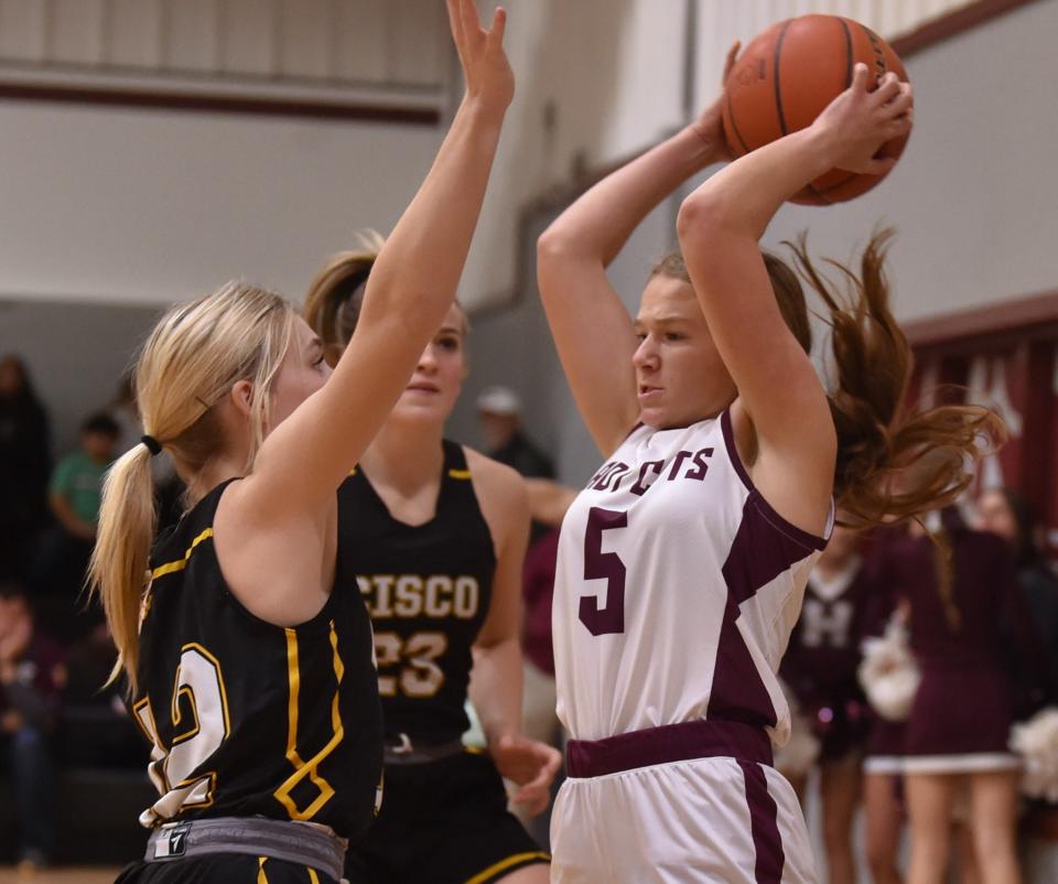 Cisco's Katelynn Bailey, left, and Pearson Hearne defend against Hawley's Kynzi O'Shields. Cisco beat the Lady Cats 61-22 in the District 10-2A game Friday at Hawley.