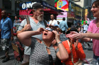 <p>A woman looks overjoyed as she watches the total solar eclipse in Times Square, New York City, on Aug. 21, 2017. (Gordon Donovan/Yahoo News) </p>