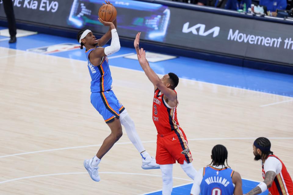 Thunder guard Shai Gilgeous-Alexander (2) shoots over Pelicans guard CJ McCollum (3) during Game 2 of their first-round playoff series Wednesday night at Paycom Center. Oklahoma City won 124-92.