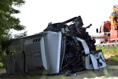 A bus is seen lying sideways after crashing in Middelkerke, Belgium, June 28, 2015. REUTERS/Eric Vidal