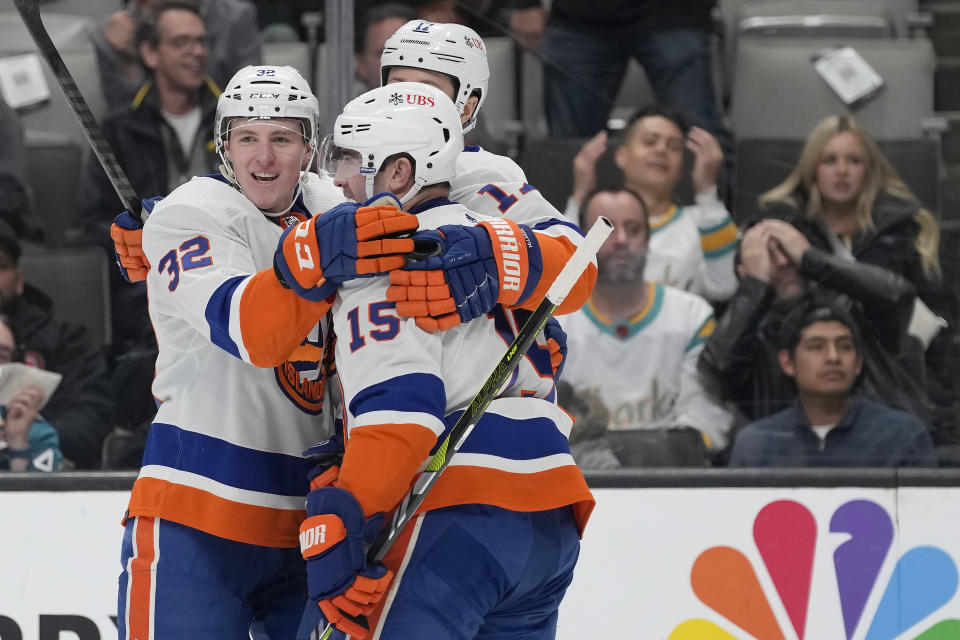 New York Islanders center Kyle MacLean, left, is congratulated by left wing Matt Martin, rear, and right wing Cal Clutterbuck (15) after scoring against the San Jose Sharks during the second period of an NHL hockey game in San Jose, Calif., Thursday, March 7, 2024. (AP Photo/Jeff Chiu)