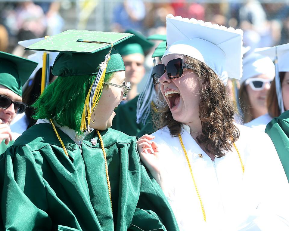 Seniors Sophie Costello, right, and Emily Harrington Brown share a laugh about their hangout at SweetFrog during Marshfield High’s graduation at Marshfield High School on Saturday, June 4, 2022.