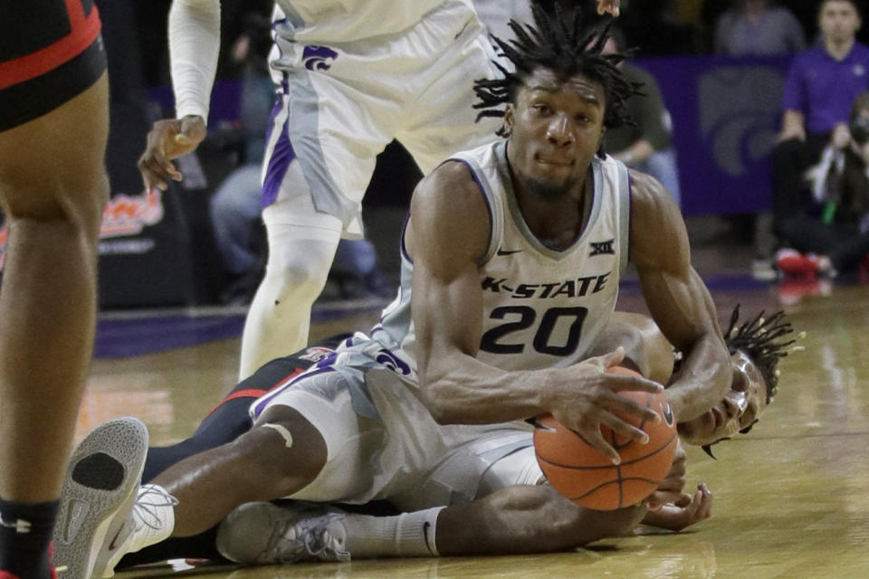 Kansas State forward Xavier Sneed (20) goes to the floor after the ball with Texas Tech guard Jahmi'us Ramsey, back, during the second half of an NCAA college basketball game in Manhattan, Kan., Tuesday, Jan. 14, 2020. Texas Tech defeated Kansas State 77-63. (AP Photo/Orlin Wagner)