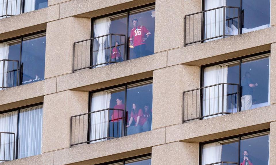 People look out of their windows from The Westin Hotel after a shooting broke out following the Kansas City Chiefs Super Bowl LVIII victory parade on Wednesday, Feb. 14, 2024, in Kansas City.