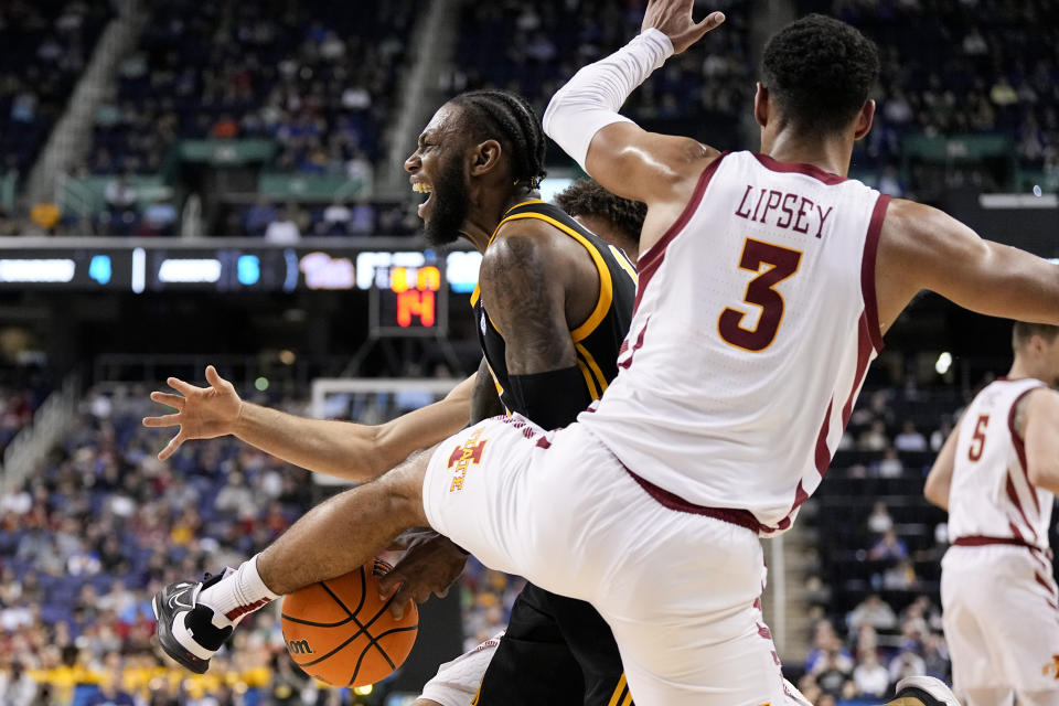 Pittsburgh guard Jamarius Burton is fouled by Iowa State guard Tamin Lipsey during the first half of a first-round college basketball game in the NCAA Tournament on Friday, March 17, 2023, in Greensboro, N.C. (AP Photo/Chris Carlson)