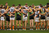 GWS and the Tigers huddled together post-game.