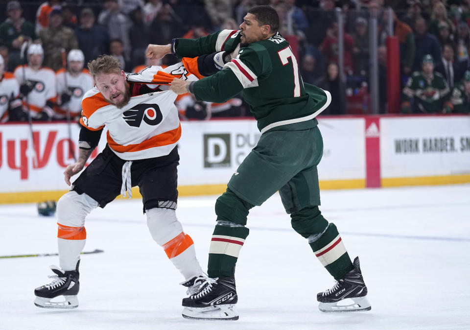 Philadelphia Flyers left wing Nicolas Deslauriers, left, and Minnesota Wild right wing Ryan Reaves fight during the first period of an NHL hockey game Thursday, Jan. 26, 2023, in St. Paul, Minn. (AP Photo/Abbie Parr)