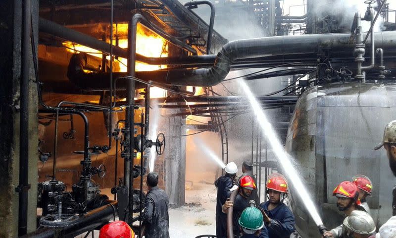 Firefighters try to put out a fire in main Homs refinery