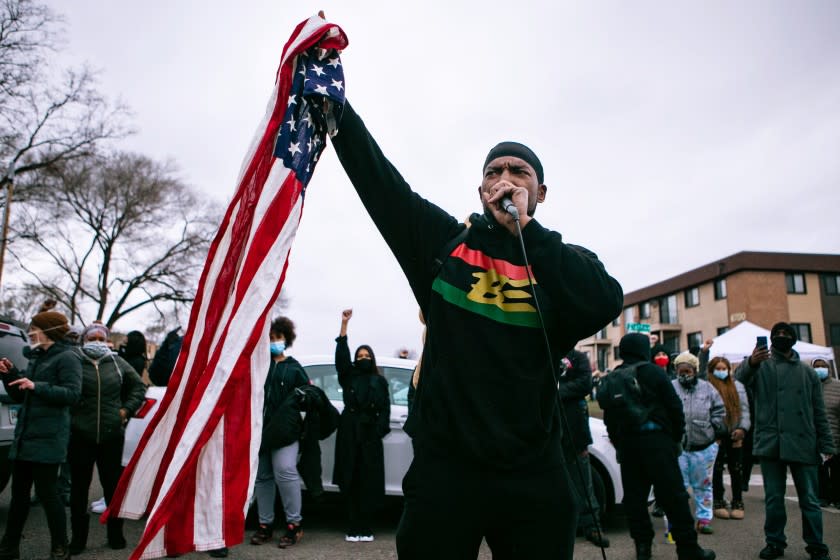 BROOKLYN CENTER, MN - APRIL 14: Michael Wilson, a community activist, speaks to the crowd of protesters gathered outside the Brooklyn Center Police Department calling for justice for Daunte Wright before curfew on Wednesday, April 14, 2021 in Brooklyn Center, MN. (Jason Armond / Los Angeles Times)