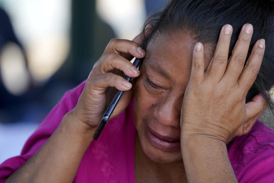 A migrant woman cries as she talks on a cellphone at a park after she and a large group of migrants who were expelled from the U.S. were pushed by Mexican authorities off an area they had been staying after their expulsion, Saturday, March 20, 2021, in Reynosa, Mexico. (AP Photo/Julio Cortez)