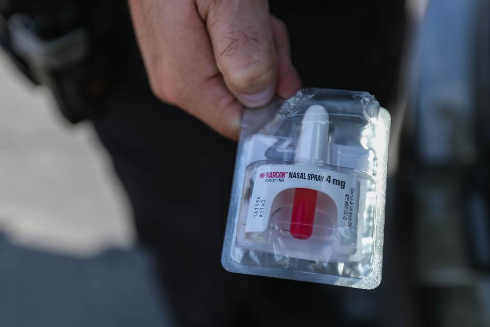 Oklahoma City police officer Sgt. Dustin Wright shows a packaged Narcan nasal spray on Aug. 9, 2022. Wright gives Narcan nasal spray to hotel clerks in case of an overdose of a guest.