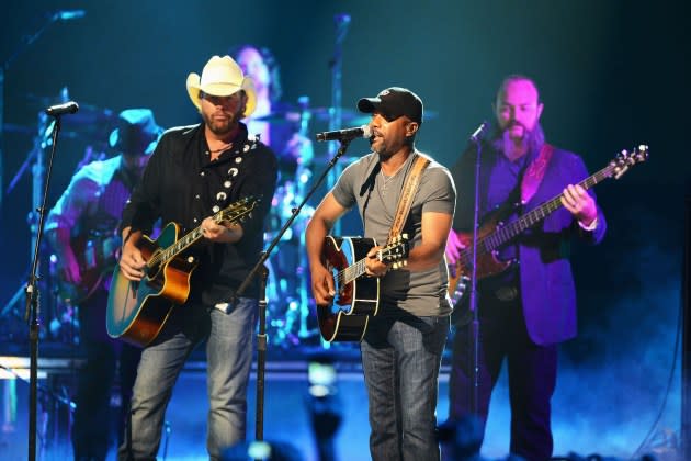 Toby Keith and Darius Rucker onstage in 2012. Rucker sang Keith's "God Love Her" in tribute to the songwriter at the Grand Ole Opry. - Credit: Jason Merritt/Getty Images