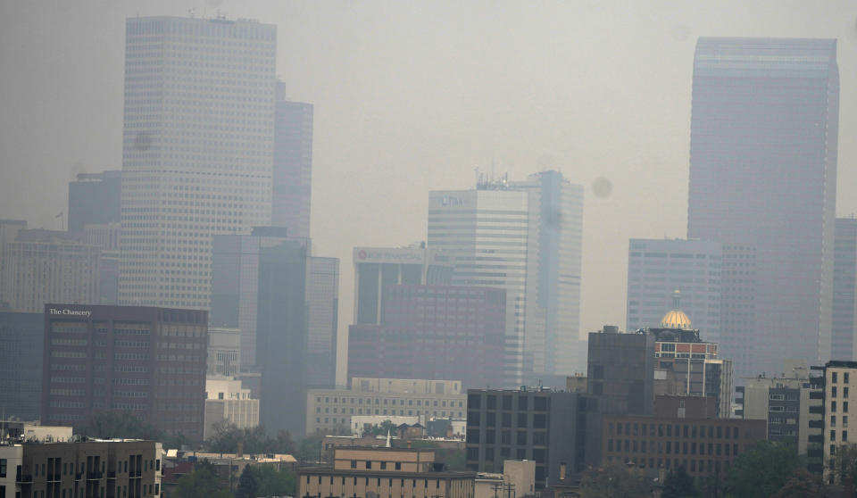 The skyline is obscured as smoke from wildfires in Alberta rolls south early Friday, May 19, 2023, in Denver. (AP Photo/David Zalubowski)