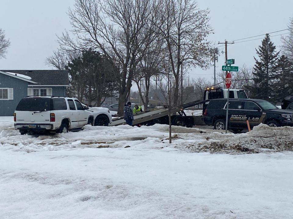 Sioux Falls crime lab officials and a tow truck respond to the scene of a shootingand hit-and-run Sunday morning in the 5300 block of W. 44th Street.