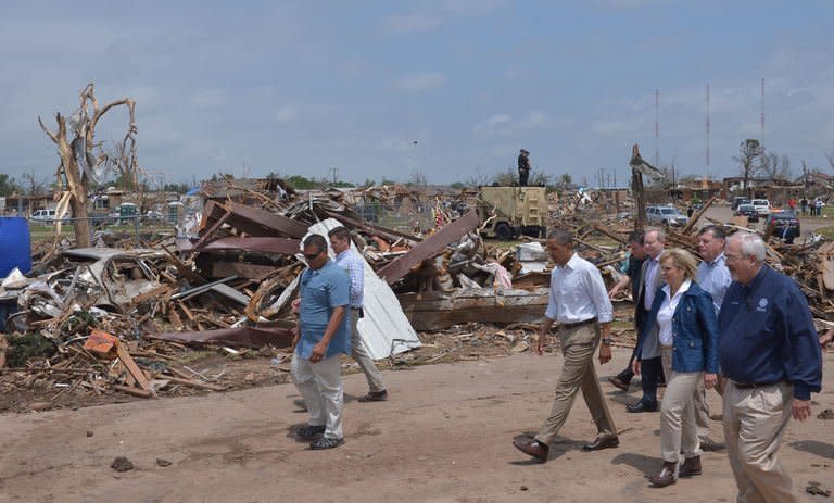 US President Barack Obama (3rd L) tours a tornado-hit area on May 26, 2013, in Moore, Oklahoma
