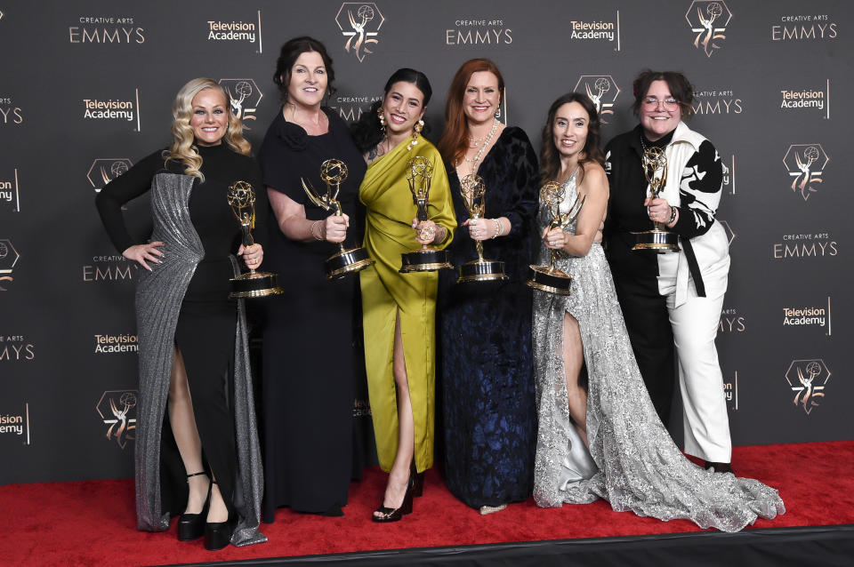 The team from "Beauty And The Beast: A 30th Celebration"pose in the press room with the award for outstanding costume for variety, nonfiction or reality programming during night two of the Creative Arts Emmy Awards on Sunday Jan. 7, 2024, at the Peacock Theater in Los Angeles. (Photo by Richard Shotwell/Invision/AP)