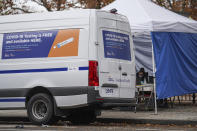 Medical works operate a COVID-19 mobile testing site, Wednesday, Nov. 11, 2020, in the Brooklyn borough of New York. Restaurants, bars and gyms will have to close at 10 p.m. across New York state in the latest effort to curb the spread of the coronavirus, Gov. Andrew Cuomo announced Wednesday. Cuomo said the new restrictions, which go into effect Friday, are necessary because new coronavirus infections have been traced to those types of activities. (AP Photo/John Minchillo)
