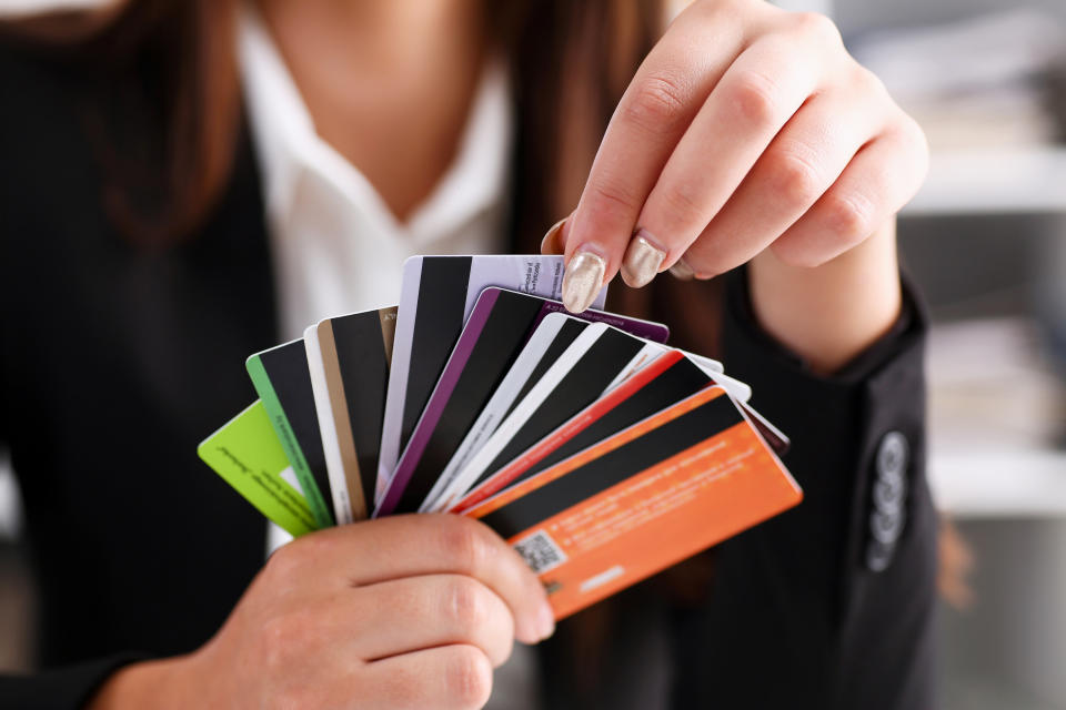 Female arm hold bunch of credit cards picking one closeup. Convenient set of funds, budget wallet deposit, wealth and effective investment, invest resources, income profit concept
