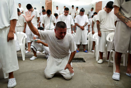 Members of the Torre Fuerte (Strong Tower) evangelical church participate in a religious service at the San Francisco Gotera prison, in San Francisco Gotera, El Salvador, March 9, 2018. Former members of the Barrio 18 gang abandoned their gang and decided to form two churches in order to leave their violent past. REUTERS/Jose Cabezas