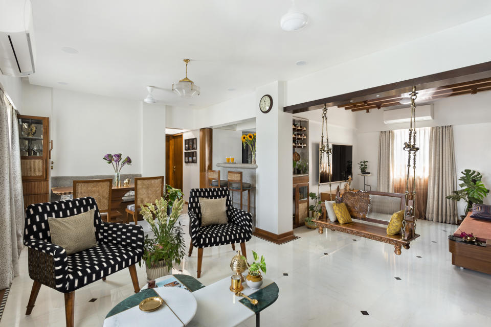 The social spaces in this 1,000-square-foot apartment flow seamlessly. Observe how materials subtly demarcate functional areas across the open plan. Terrazzo marks dining areas; restored Burma teak rafters highlight the media room; Indian stone with built-in lighting along a beam separates the formal living area from the entertainment lounge.