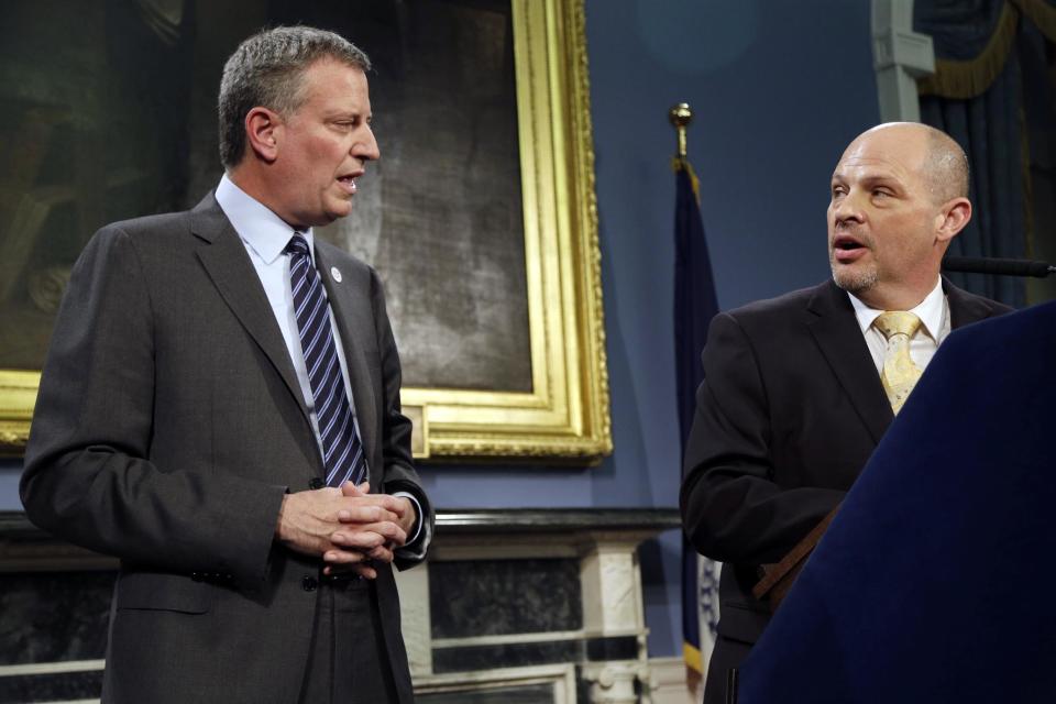 President of the United Federation of Teachers Michael Mulgrew, right, and New York City Mayor Bill de Blasio participate in a news conference at City Hall in New York, Thursday, May 1, 2014. New York City and its largest teachers union struck a deal on a new contract Thursday, ending a nearly five-year labor dispute and potentially setting a template for negotiations with the city's other unions. (AP Photo/Seth Wenig)