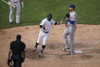 New York Yankees' Clint Frazier, left, scores the game-winning run on a wild pitch by New York Mets relief pitcher Dellin Betances, right, to close the ninth inning of a baseball game, Saturday, Aug. 29, 2020, in New York. The Yankees won 2-1. (AP Photo/John Minchillo)