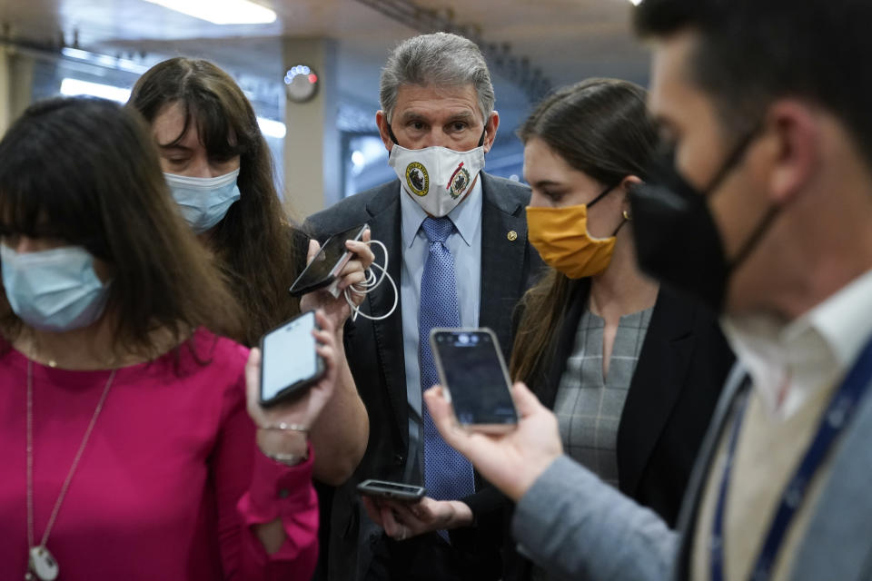 Sen. Joe Manchin, D-W.Va., center, speaks with reporters on Capitol Hill in Washington, Wednesday, Oct. 27, 2021. (AP Photo/Patrick Semansky)