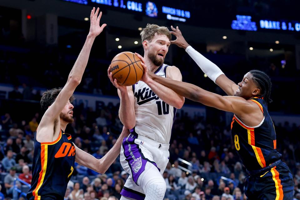 Sacramento forward Domantas Sabonis (10) jumps to pass past Oklahoma City forward Jalen Williams (8) in the fourth quarter during an NBA game between the Oklahoma City Thunder and the Sacramento Kings at the Paycom Center in Oklahoma City, on Sunday, Feb. 11, 2024.