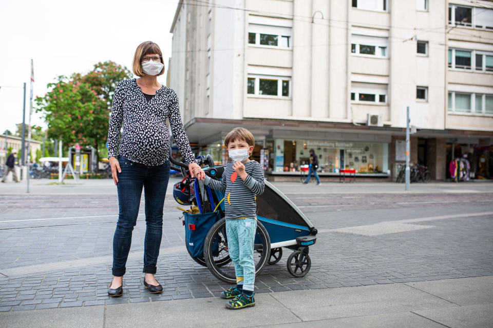 21 April 2020, Baden-Wuerttemberg, Freiburg: Jessica (l-r) and her son Juri are standing in downtown Freiburg wearing mouth and nose masks. From 27th April, it will be compulsory to wear masks when shopping and on public transport in Baden-Württemberg in order to prevent the spread of the coronavirus. Photo: Philipp von Ditfurth/dpa (Photo by Philipp von Ditfurth/picture alliance via Getty Images)