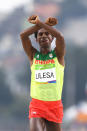 Runner Feyisa Lilesa forms a sign of protest against the Ethiopian government and its treatment of the Oromo people, a heritage which Lilesa shares.