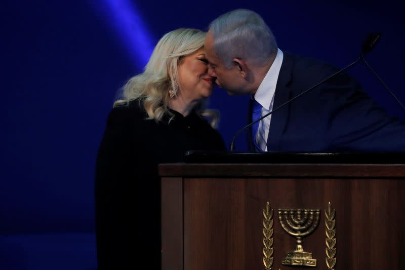 Israeli Prime Minister Benjamin Netanyahu kisses his wife Sara during his address to supporters following the announcement of exit polls in Israel's election at his Likud party headquarters in Tel Aviv