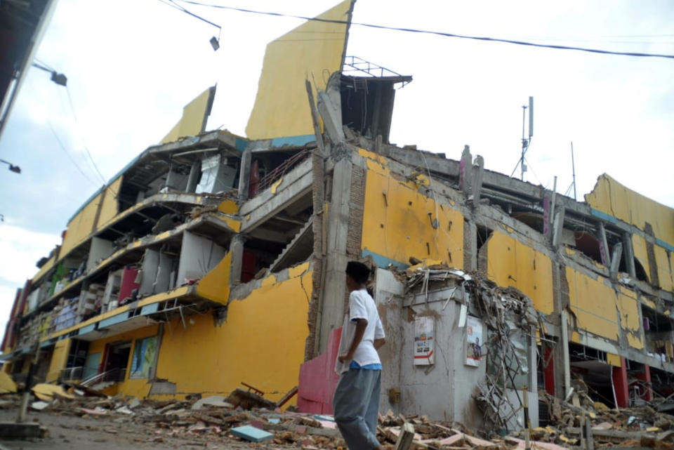 A man surveys the damage following earthquakes and a tsunami in Palu, Central Sulawesi, Indonesia, Saturday, Sept. 29, 2018. A tsunami swept away buildings and killed large number of people on the Indonesian island of Sulawesi, dumping victims caught in its relentless path across a devastated landscape that rescuers were struggling to reach Saturday, hindered by damaged roads and broken communications. (AP Photo/Rifki)