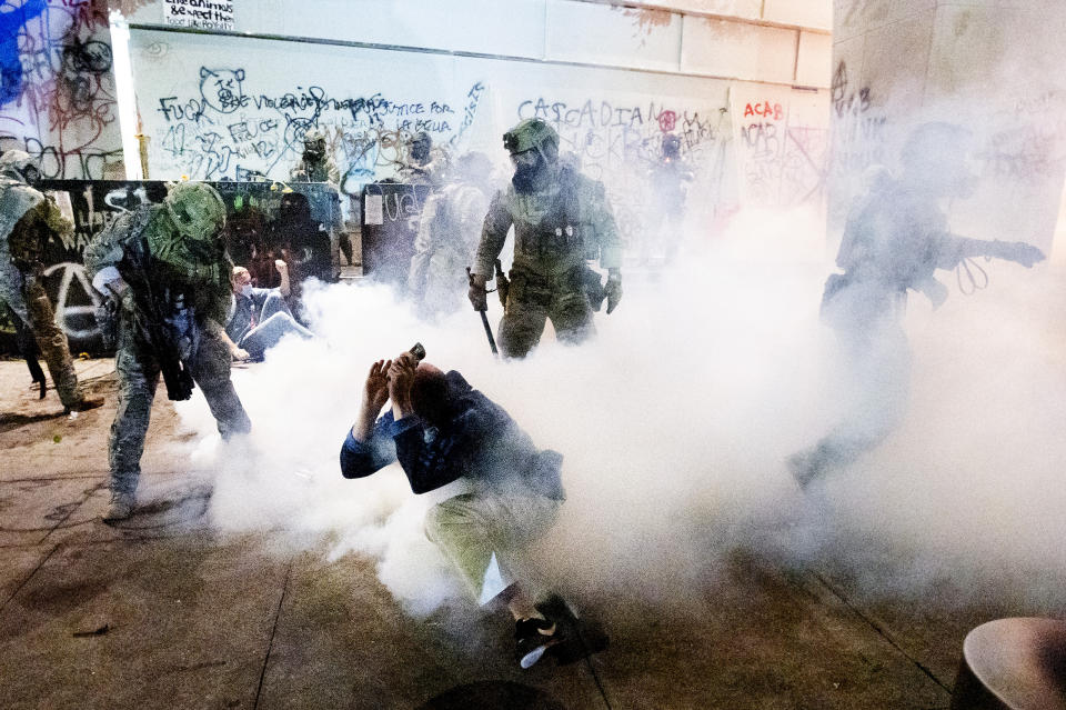 Federal officers use chemical irritants and crowd control munitions to disperse Black Lives Matter protesters outside the Mark O. Hatfield United States Courthouse on Wednesday, July 22, 2020, in Portland, Ore. (AP Photo/Noah Berger)