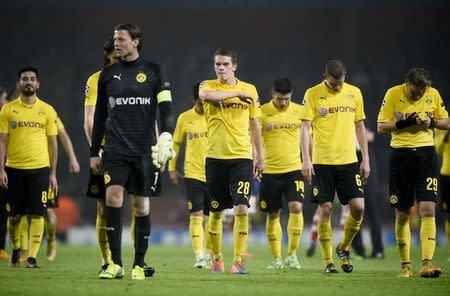 Borussia Dortmund players leave the pitch dejected after losing to Arsenal in their Champions League group D soccer match in London November 26, 2014. Arsenal won the match 2-0. REUTERS/Dylan Martinez