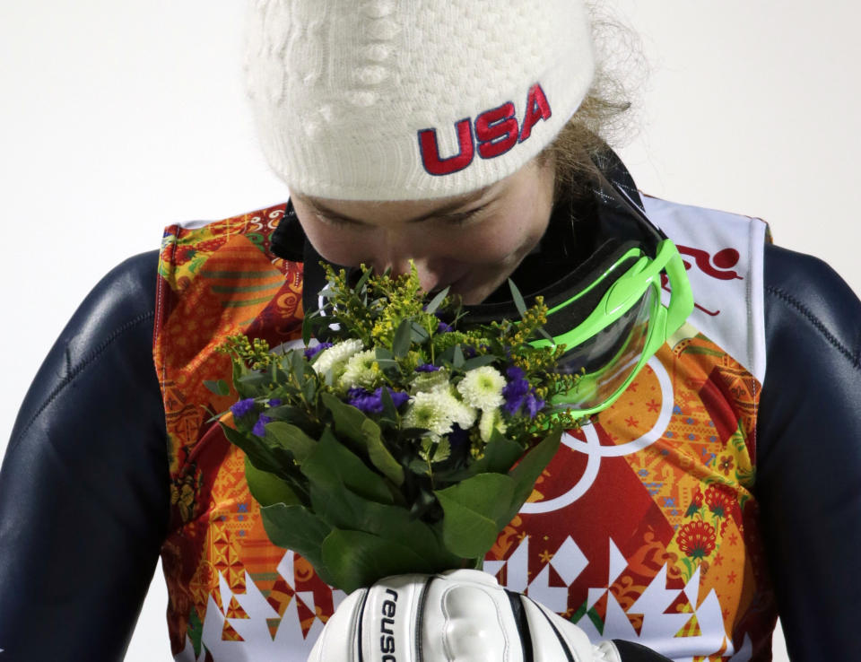 Women's slalom gold medal winner Mikaela Shiffrin of the United States smells her bouquet during a flower ceremony at the Sochi 2014 Winter Olympics, Friday, Feb. 21, 2014, in Krasnaya Polyana, Russia. (AP Photo/Gero Breloer)
