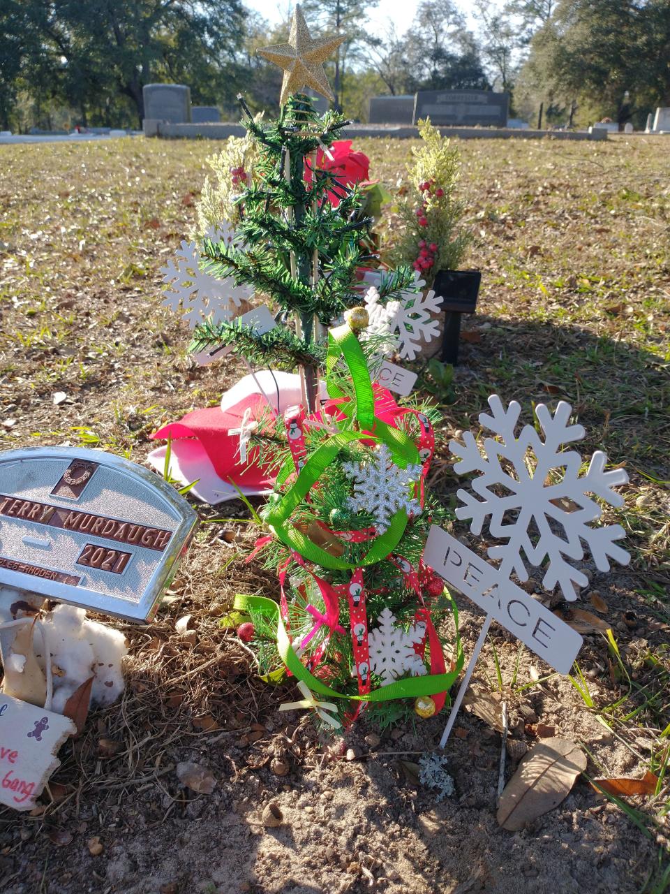 Christmas trees and trinkets adorn the gravesites of Maggie and Paul Murdaugh, murdered two Christmases ago in June of 2021.