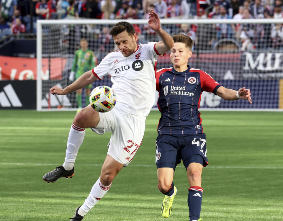 Toronto FC defender Shane O'Neill (27) defends the ball against New England Revolution forward Esmir Bajraktarevic (47) in the second half of an MLS soccer match Sunday, March 3, 2024, in Foxborough, Mass. (AP Photo/Mark Stockwell)