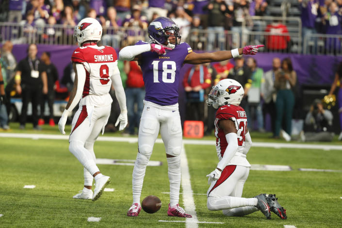 Minnesota Vikings wide receiver Justin Jefferson (18) celebrates a first down in front of Arizona Cardinals safety Jalen Thompson, right, during the first half of an NFL football game, Sunday, Oct. 30, 2022, in Minneapolis. (AP Photo/Bruce Kluckhohn)