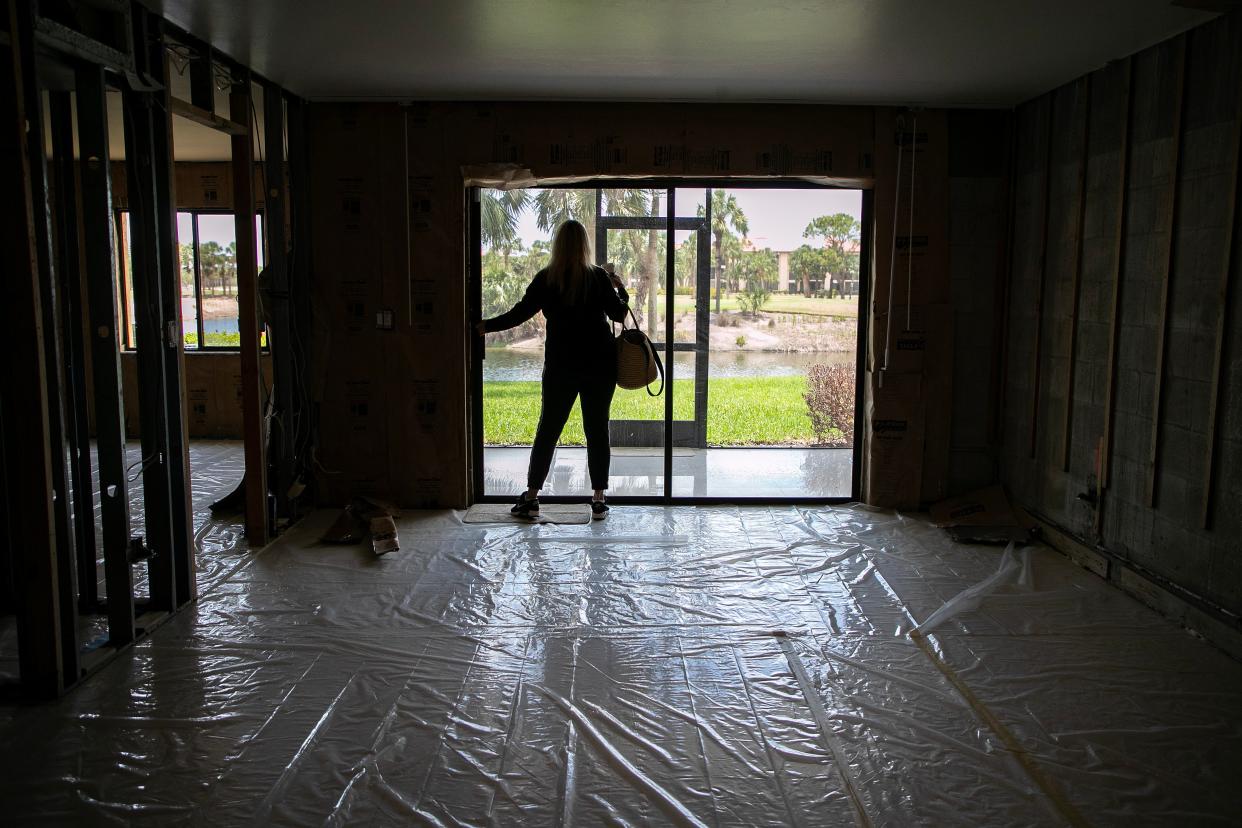 Cher Luisi opens up her condo after arriving to check on it on June 8 in south Fort Myers. The condo was flooded in Hurricane Ian, and she has fought for months with her insurance company to get her payout.