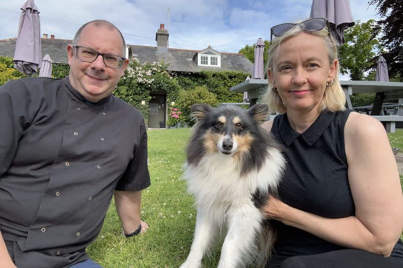 Couple with dog outside pub