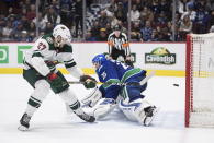 FILE - In this Feb. 19, 2020, file photo, Minnesota Wild's Alex Galchenyuk, left, scores against Vancouver Canucks goalie Jacob Markstrom, of Sweden, during the shootout in an NHL hockey game in Vancouver, British Columbia. The Canucks get Markstrom back from a knee injury, and he has had the benefit of skating at home in Sweden during the pause. (Darryl Dyck/The Canadian Press via AP, File)